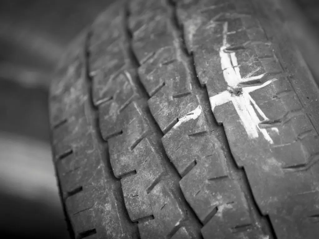 Anvelopă auto cu marcaj alb pentru reparație pană prin vulcanizare la service Carfix Londra